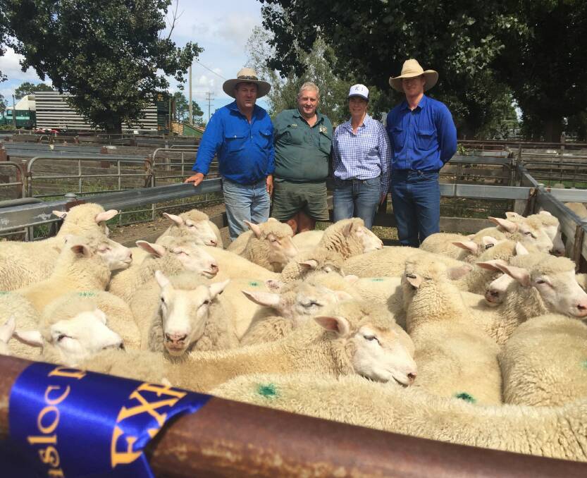 Andrew Say with Peter and Julie Donnelly in their prize-winning pen of sheep at the Yasloc show and sale held at the Glen Innes saleyards on Tuesday morning.