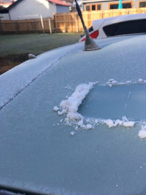 Chipping the ice off a car in Armidale on Tuesday morning. Photo: Madeline Link.