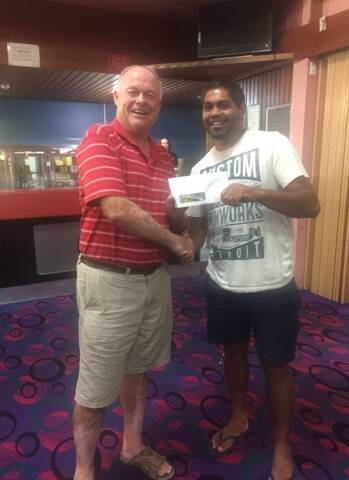 Russell Meehan presenting runner-up to Nicolas Levy at the poker event.