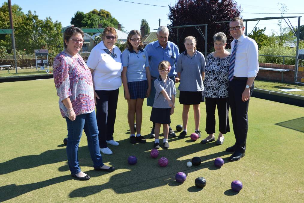 Bowled over: Northern Tablelands MP Adam Marshall, right, delivered more than just a couple of ends when he bowled up to the Glen Innes Bowling Club – Kylie Ross, left, Isabel Dawson, Hayley Ross, Terry Donald, Indie Ross, Brittany Ross, Catherine Donald on the green.