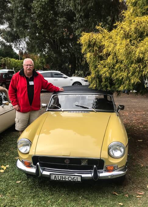 Brian McKenzie with his yellow MGB 1972 vintage car.