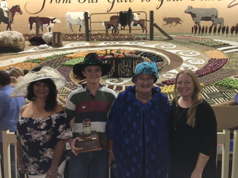 TOP TROPHY: Representatives from Glen Innes at the Royal Easter Show in Sydney, excited after taking out the wool trophy for the fourth time in the District Exhibits. 