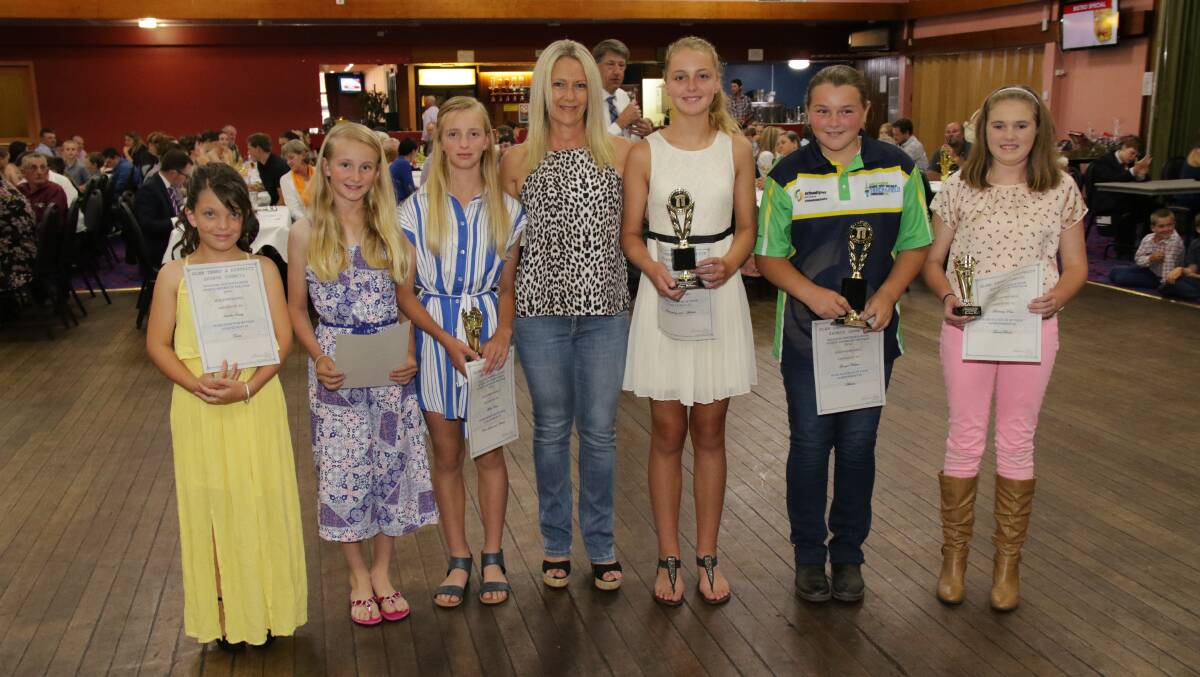 Junior girls proudly show their awards.