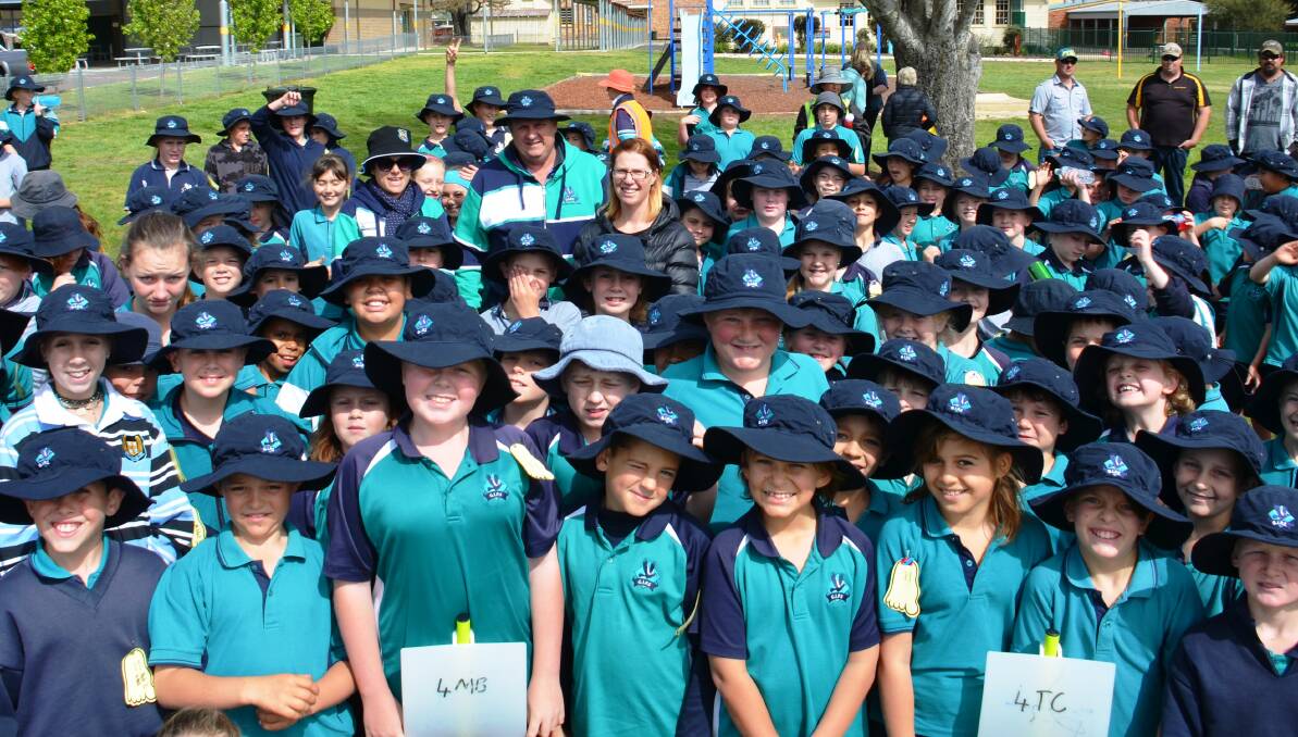 HATS ON: Glen Innes Public School students with Assistant Principal Jane Lawrence  and Principal Anthony Buckley wearing their hats. 