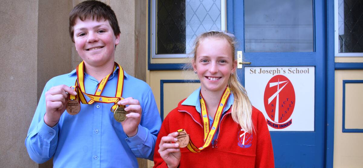 PODIUM FINISH: Adam Campbell and Mollie Cave with the medals they won at the recent  Armidale Diocese Polding Athletics Carnival.