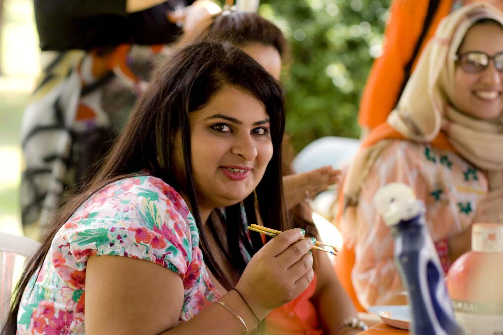 Rimoly Mody enjoying some food from harmony day, the Midwinter feast is expected to be a day of food, fun and music.