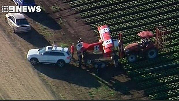 Emergency crews respond to reports that a light plane crash landed in a lettuce field near Gatton. Photo: Nine News Queensland