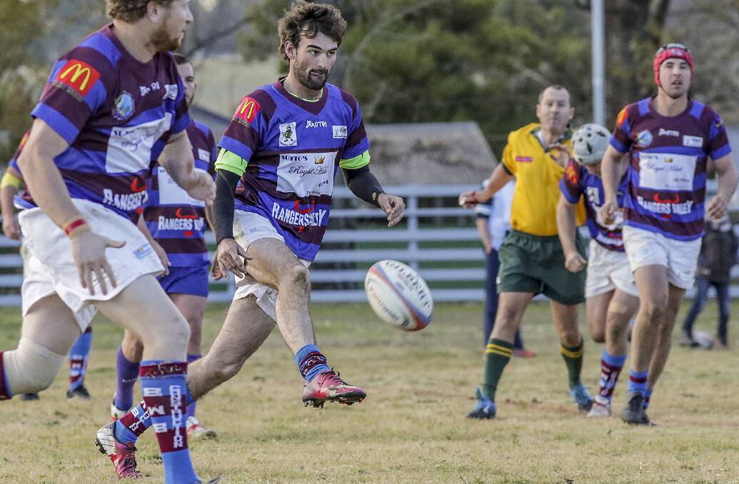 GIVE CANCER THE BOOT: Jeremy Hallam gets a kick away in the GhostStags match against the Barbarians. The local club hosted a fundraiser for local kids, Tommy Gill and Josie Grob, suffering lymphoblastic leukaemia. Photo: Tony Grant