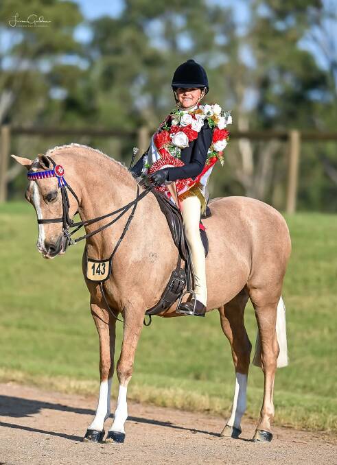 Sophia Nugent and Elvonara Park Kandyman after winning the nine and under 12 rider class at Grand Nationals. Picture by Lisa Gordon - Little More Grace Photography