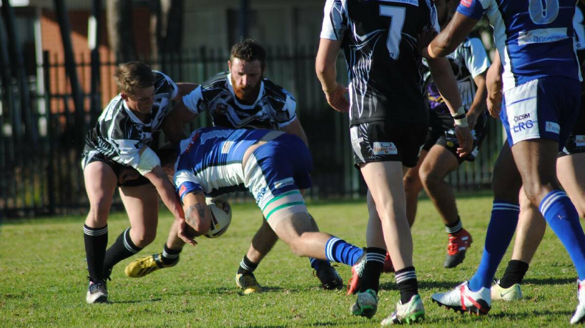 TOUGH DAY OUT: Magpies try to stop Boars' Conor Ryan. Photo: Deb Holland.