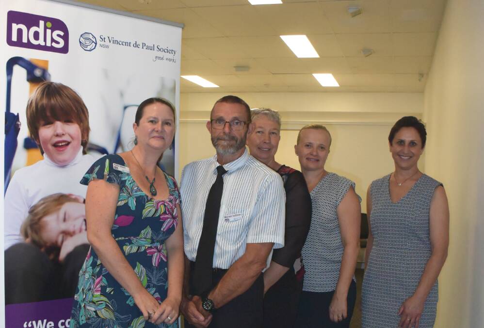 Senior operations manager Kellie Gilbert and district manager Warren Sullivan with NDIS staff Karen Symons, Dianne Lucas and Katrina Armstrong.