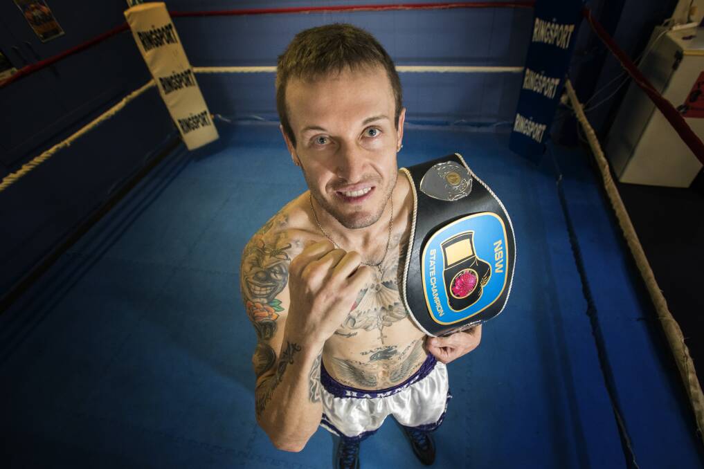 Nice belt: Glen Innes boxing export Michael 'Hammo' Hamilton is the proud owner of the NSW State Lightweight title after defeating John Min. Photo: Peter Hardin 160317PHF017