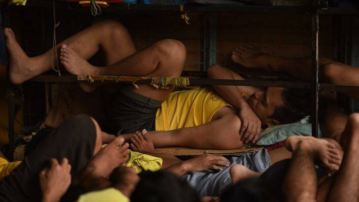 Some of the 3562 Inmates sleep on any space they can find in a classroom in Quezon city jail, Philippines.  Photo: Kate Geraghty