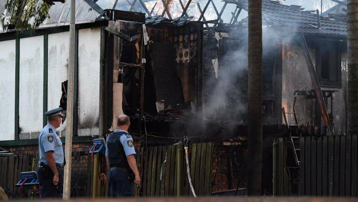 Police remain at the scene of a house fire on Paringa Place in Bangor. Photo: Peter Rae