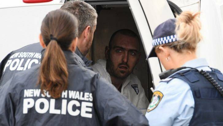 Police speak to a man who escaped from the house on Paringa Place in Bangor. Photo: Peter Rae