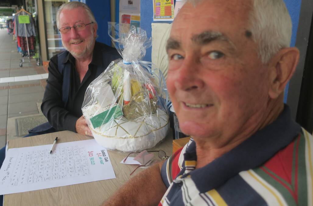 Terry Donald (right) and Michael McNamara, selling tickets for a raffle outside the Community Centr on its open day.