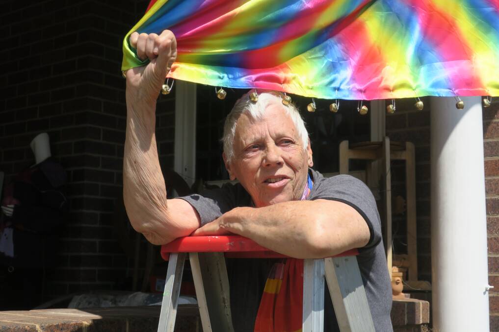 OPPOSING VIEWS: Nola Taylor with the banner with bells at her place, which is in full view of the Anglican Church. 