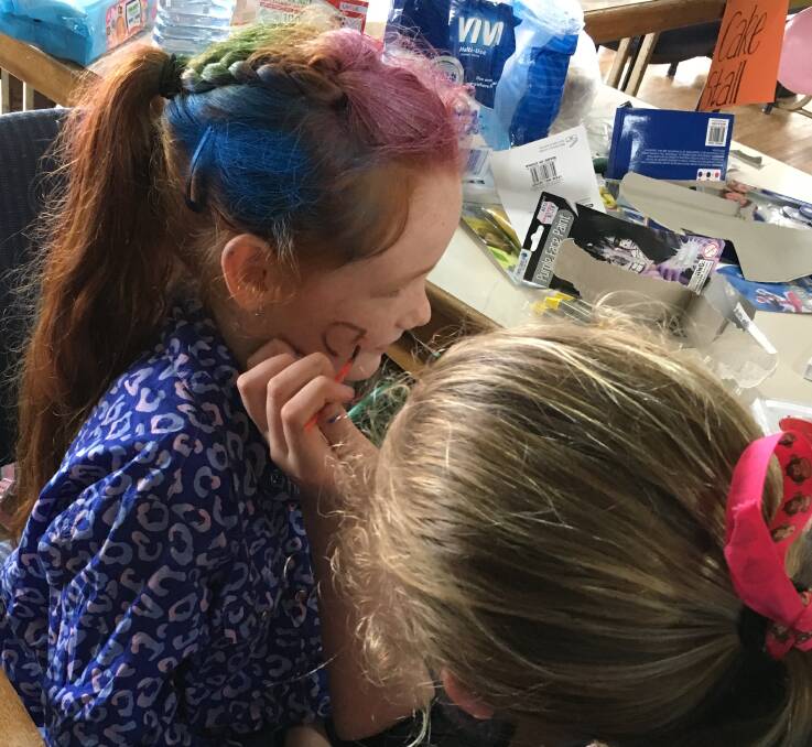 Ellie-May Campbell having her face painted to raise money.