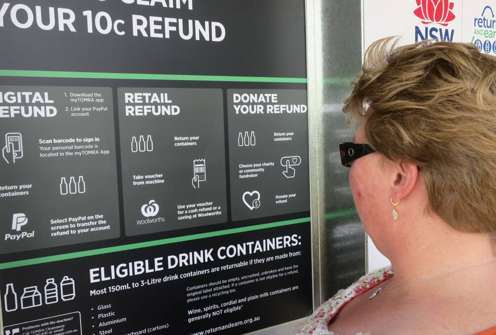 New scheme: Renee Newberry at Woolworths in Glen Innes studying how to get money back on cans, cartons and bottles from 150 ml to 3L in size. 