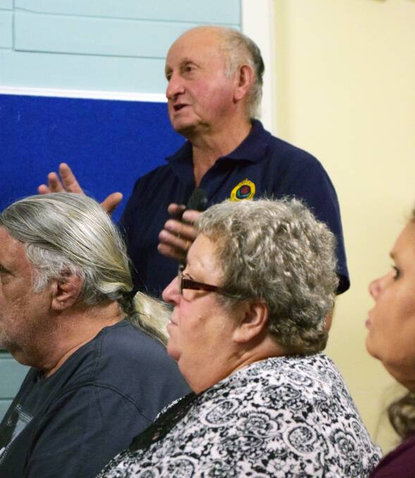Local emergency serviceman Brian Barrett addresses the public meeting in Deepwater