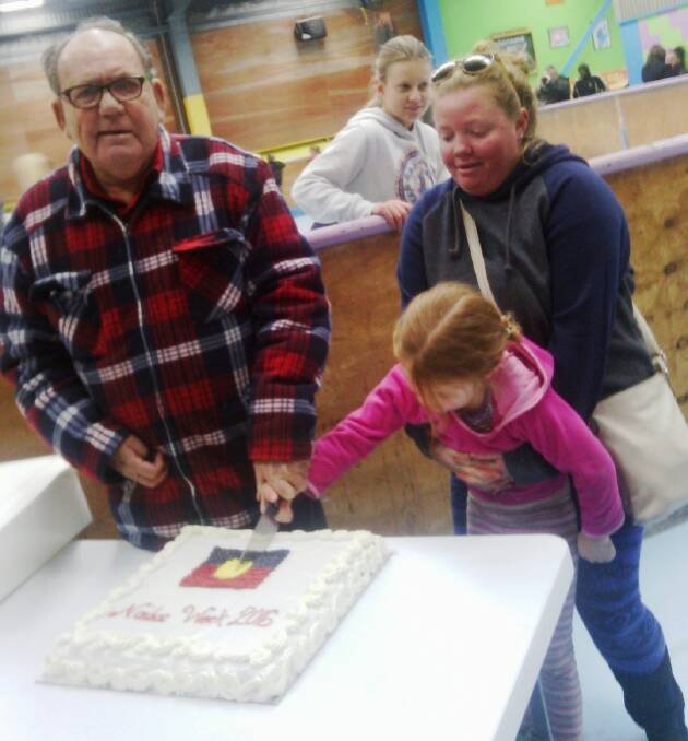 CUTTING THE CAKE: Poppi-Lee Proctor and her mum, Teniah Villiers, helped Ngoorabul elder, John Kirk, cut the NAIDOC cake.  