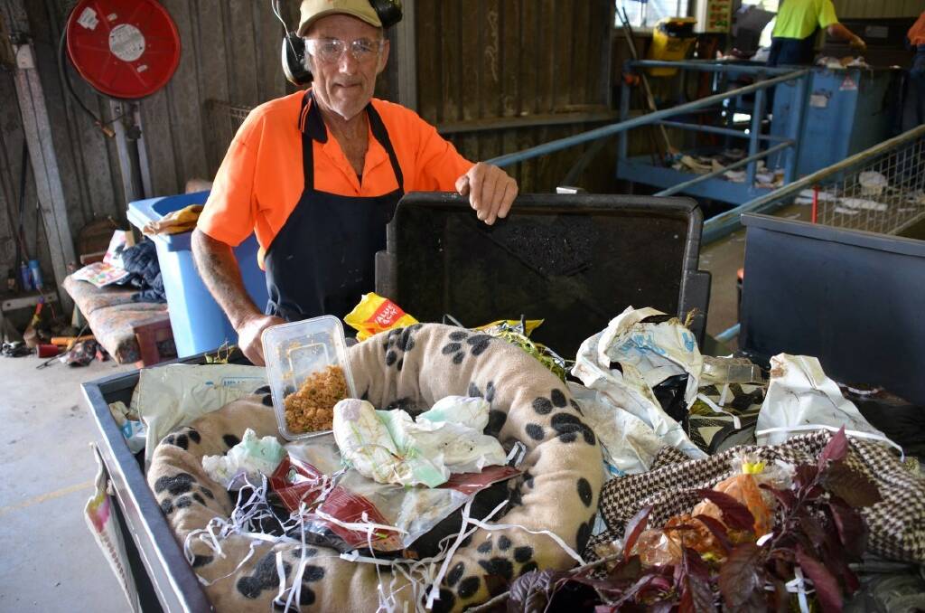 RECYCLING MAYHEM: Mark Williams with a sample of the disgusting non-recyclable material Glen Innes residents are putting in their recyclable bins.