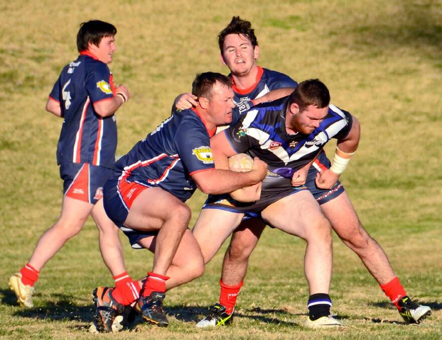 ATTACKING: Craig Browne, who scored three tries, takes on the Roosters defence.