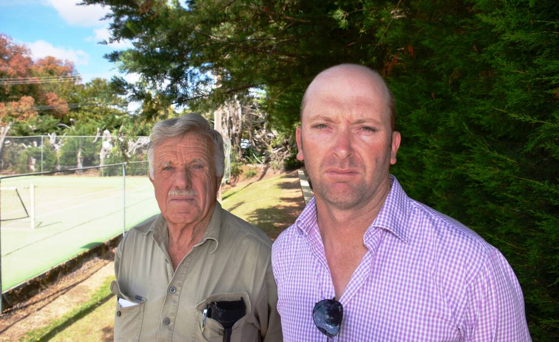 Peter Haselwood and Peter Cole next to the hedge at the tennis courts.