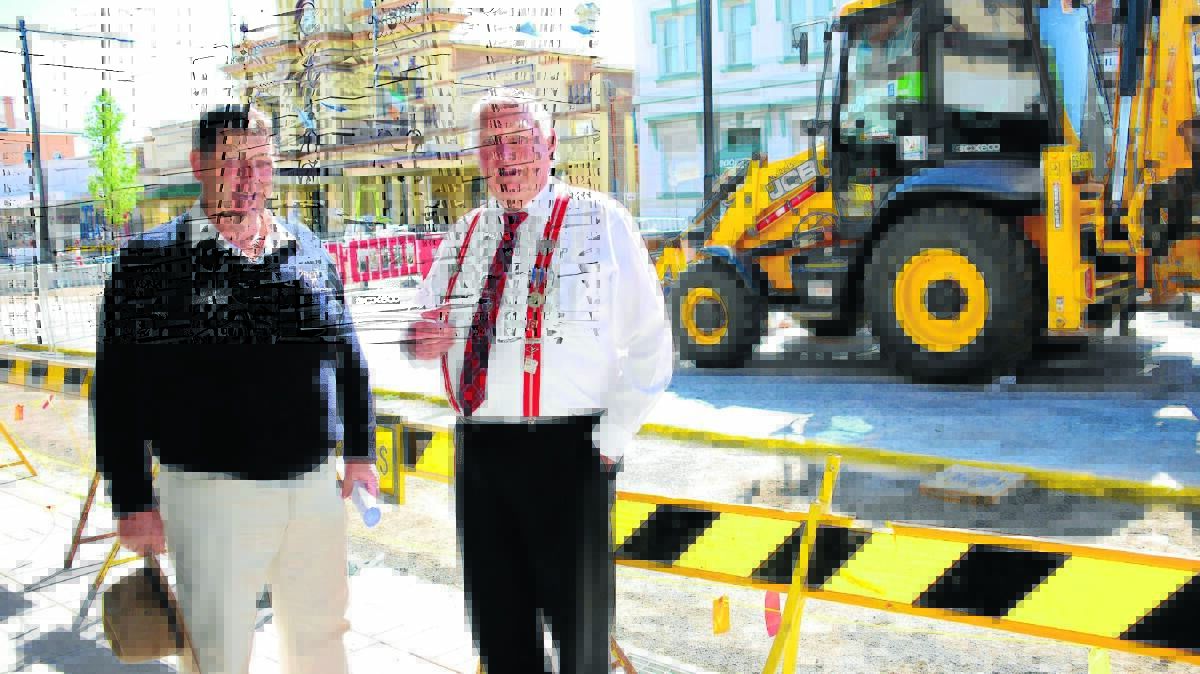 o Holding their breath: Business In Glen’s Jim Ritchie and Howard Eastwood are looking forward to when the Grey St bulldozers are replaced by Christmas decorations.