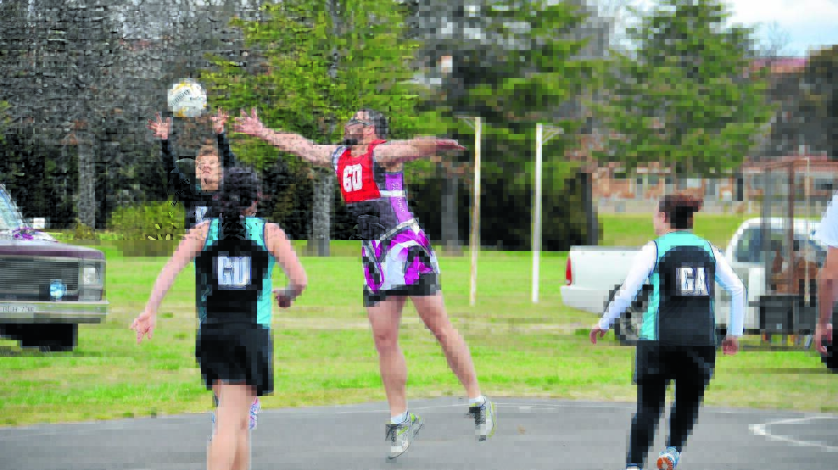 o Fashion statement: Carla Bryant steals the ball from tres chic interchange Brad Wood in a memorable charity match during the recent Glen Innes Netball grand final.