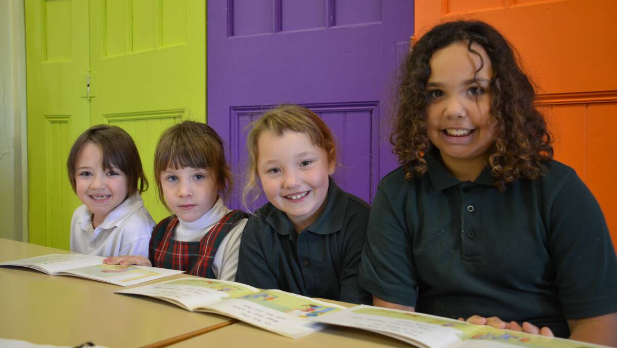 o Happy readers: Glen Innes West Infants School students Hailey Smith, Reghan Mitchell, Jazmyn Styles and Tarnie Wilkinson get their noses into books in their MiniLit session.