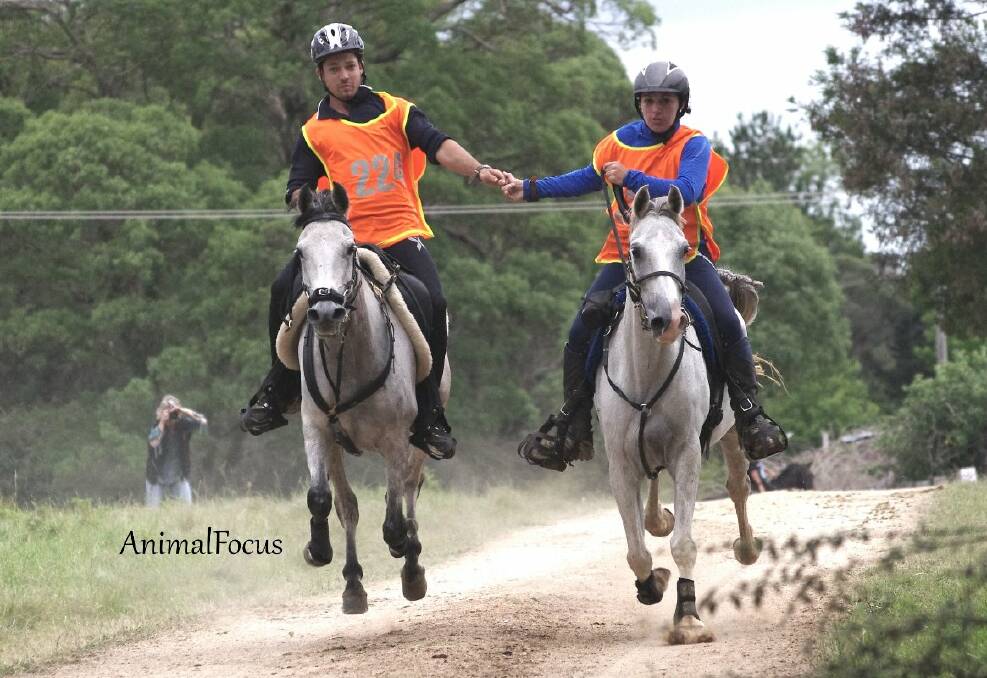 o Endurance: Ben Hudson riding Oso Edith (holding hands in a gallop finish with Camille Champagne riding Cameo Mazquerade), was first across the line in the 160km event in a time of 10 hrs 23mins 59 secs. Photo by Jo Arblaster