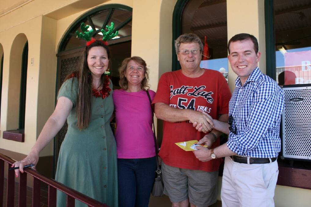 o Big bucks: Garry Brewer won the $5000 major prize in the Spend In Glen promotion, pictured receiving his cash card from member for Northern Tablelands Adam Marshall, along with organising committee member Nicole Schafer and Sheree Brewer.