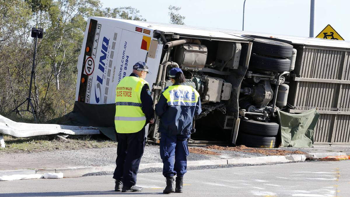 Investigators at the scene of a bus crash near Greta in the NSW Hunter Valley. Picture by AAP Image/Darren Pateman