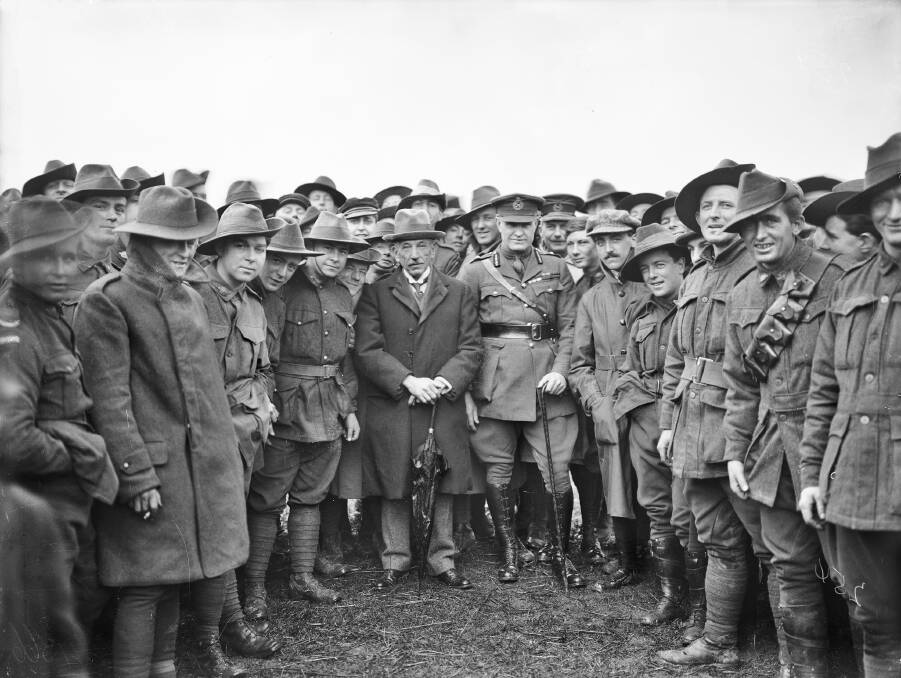 PRESENT AND FUTURE: Sir William Glasgow, Commander of Australia’s 1st Division in 1918 and later High Commissioner to Canada, next to Australian Prime Minister Billy Hughes with AIF soldiers in Belgium in February 1919. Picture: AWM E04366