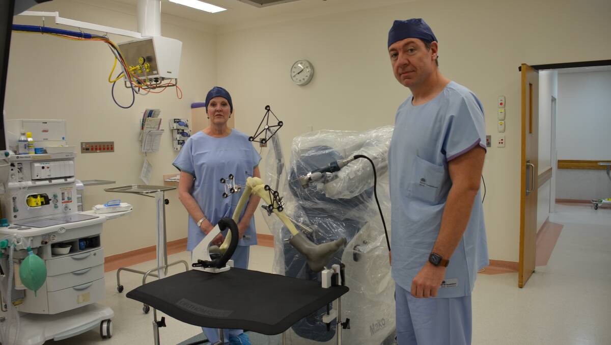 Armidale Private Hospital CEO Mary Single with Dr Neil Ferguson and the Mako robotic arm. Photo Vanessa Arundale.