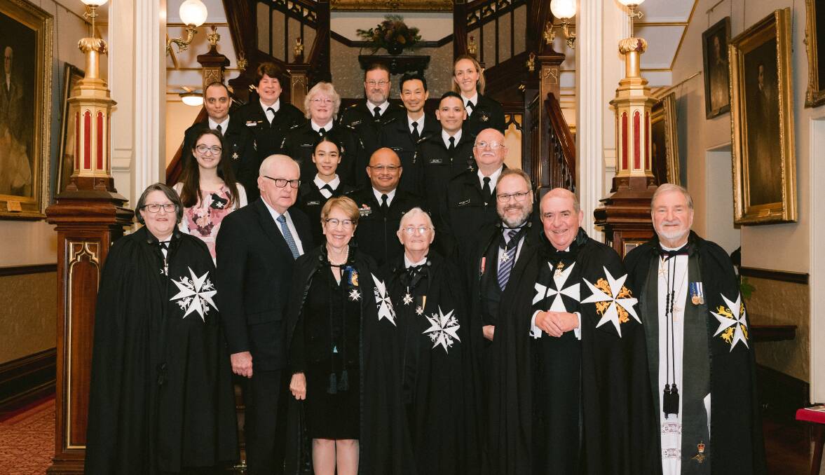 Penelope Glennan (top right) with the other 15 St John Ambulance NSW members who were awarded The Order of St John last month. 