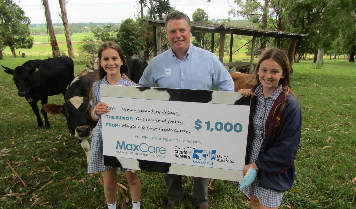 Drouin Secondary College students Portia and Jordyn with MaxCare sales manager Adam Plant, after winning a prize for their ad campaign for the dairy sector in the 2020 online Cows Create Careers program.