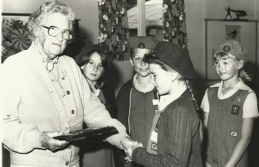 GIRL GUIDES: Theodora Priest presents an award to Cindy OBrien. Donna Walters is on the right of Theodora.
