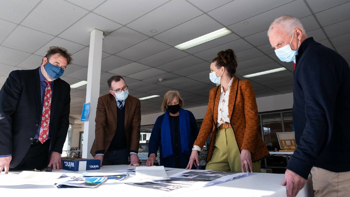 Glen Innes Severn Council General Manager Craig Bennett, left, Northern Tablelands MP Adam Marshall, Mayor Carol Sparks, Manager Economic Development Margot Davis and Director of Development, Planning and Regulatory Services Graham Price inspect plans for the buildings fit out.