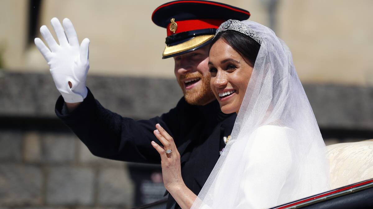 Britain's Prince Harry and his wife Meghan Markle ride a horse-drawn carriage, after their wedding ceremony at St. George's Chapel in Windsor Castle in Windsor, near London, England, Saturday, May 19, 2018. (Phil Noble/pool photo via AP)