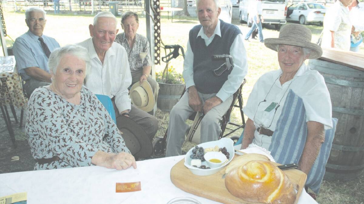 Homecoming: Cook book writer and fresh food advocate Margaret Fulton catches up at the Glen Innes Show with two of her former Glen Innes High School classmates Hec Miller (second from left) and Angus Mott (second from right) while other residents (at rear) Harvey Young, Peter Campbell and Jean Mott (far right) join in.