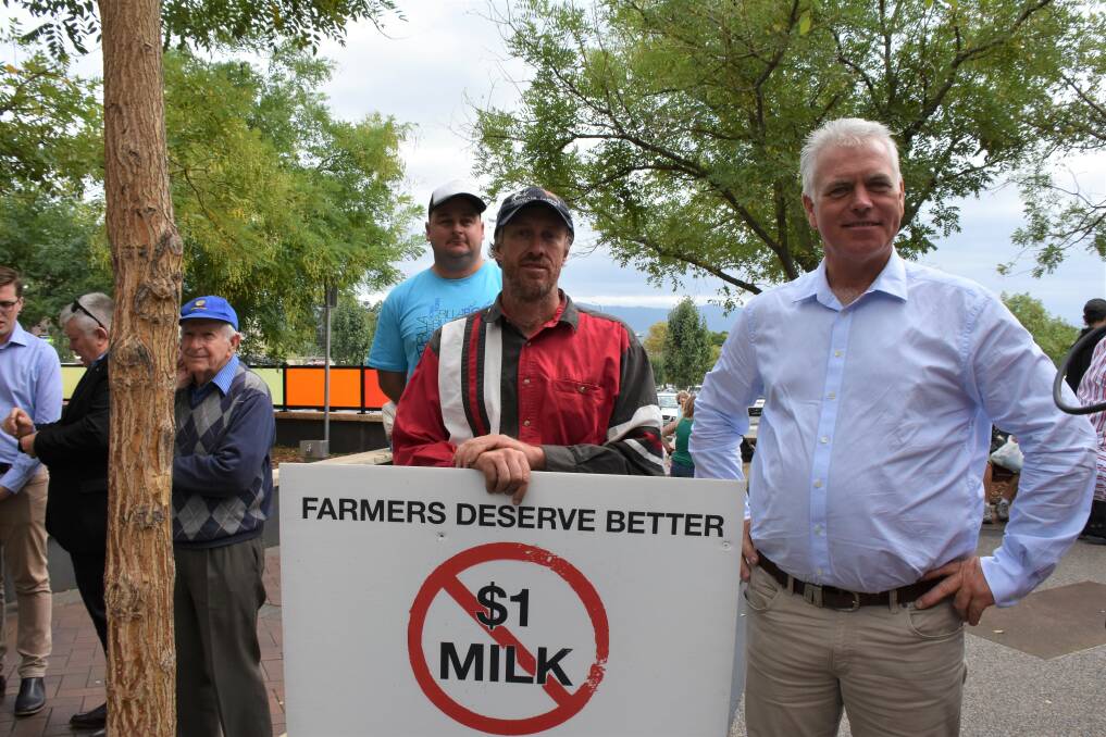 STRONG PRESENCE: Alan Timbs and local dairy farmers Tim Cochrane and Robert Miller in Nowra on Friday before Prime Minister Scott Morrison showed up. Picture: Rebecca Fist