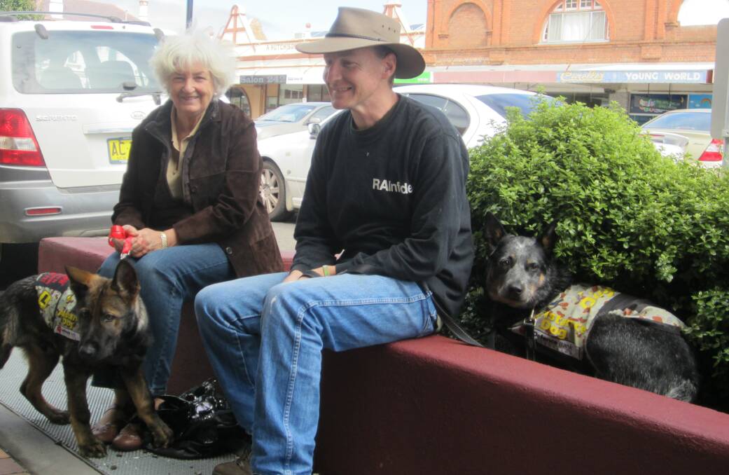 Judy Fraser with Marshall and Michael Butcher with Deoge take a break outside Town Hall.