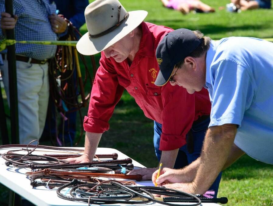 Judges Anthony Rennick and Rodney Botfield review whips that they had just judged at last year's competition.