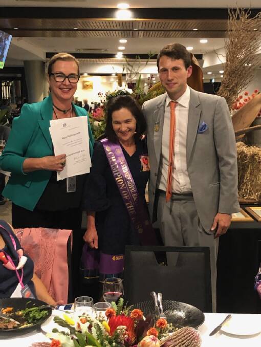 RAS councillor Alison Renwicke and Easter Show Fine Arts Committee chair Evan Hughes flank Mary Hollingworth, this year's Champion of the Show.