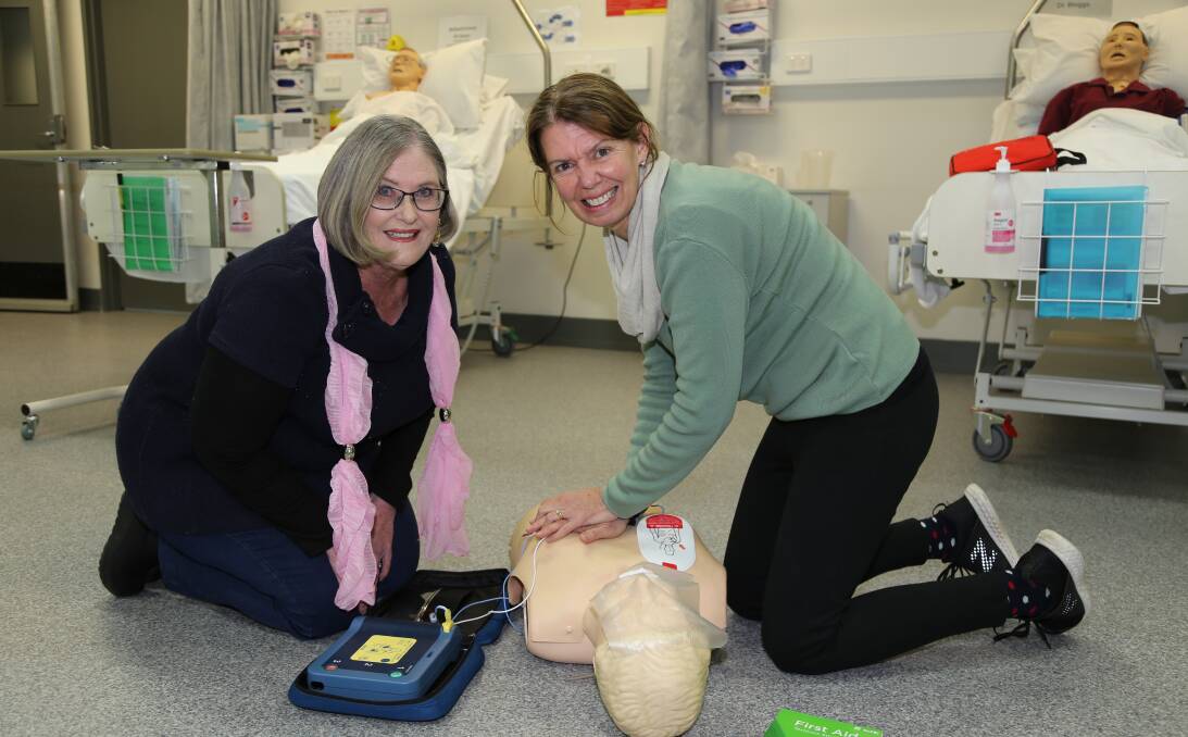 TAFE NSW First Aid Teachers Suzanne Reynolds and Cindy Williams practise their technique on a mannequin. 