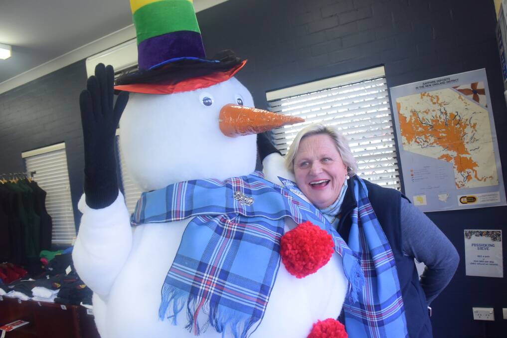 This frosty chap created by the Mens Shed -- seen here cuddling up to the Visitor Information Centre's Sal Molesworth -- will be relocating to a highway roundabout to direct visitors to the Chill N Glen festival this Saturday.