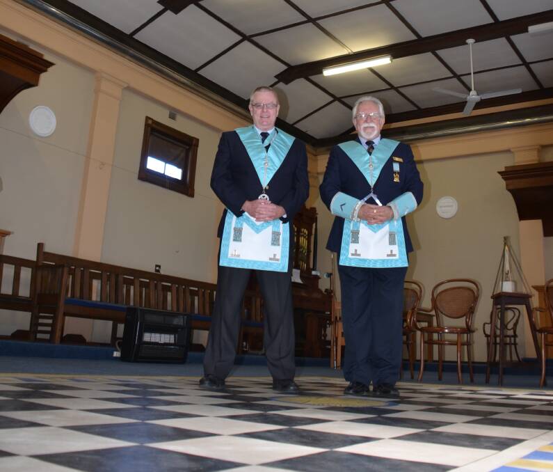 Glen Innes Freemasons Lodge Secretary Russell Long and Worshipful Master Jim Donald in their regalia, on the 'mosaic pavement' around which so many of the lodge's rituals are based. The Freemansons' 300th anniversary will be celebrated in Glen Innes.