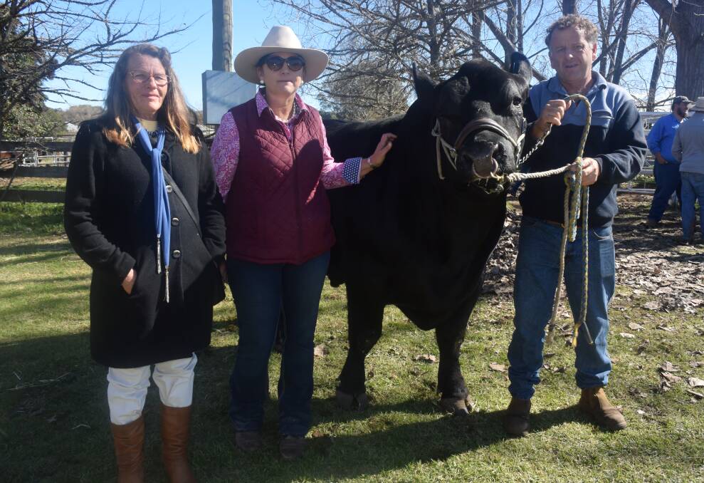 Buyer of Lot 1 for $16,000 Celia Mackay with Sixpence Park's Linda and Glen Martin and the top-priced black Simental bull.